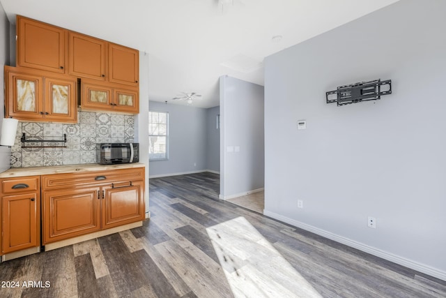 kitchen featuring backsplash, ceiling fan, and hardwood / wood-style flooring