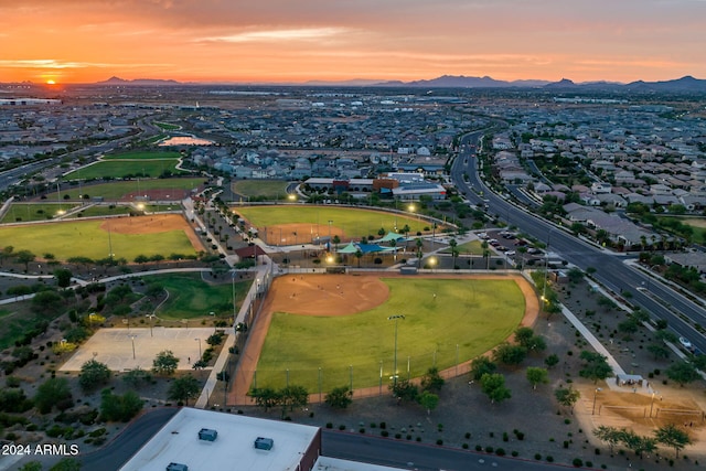 aerial view at dusk featuring a mountain view