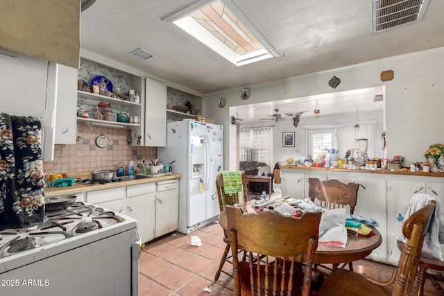 2944 W Northern Ave, Phoenix, AZ 85051 - kitchen with white appliances, ornamental molding, backsplash, light countertops, and open shelves
