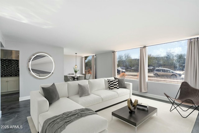 living room featuring a wealth of natural light and concrete floors