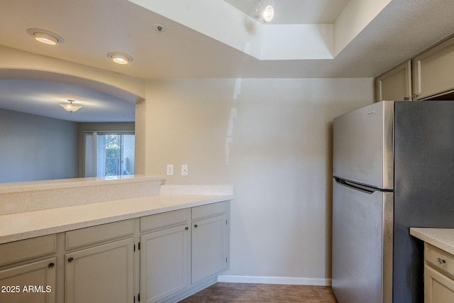 kitchen featuring stainless steel fridge and light wood-type flooring