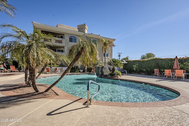 view of pool featuring pool water feature and a patio