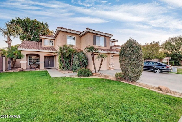 mediterranean / spanish-style home featuring a front yard, stucco siding, concrete driveway, a garage, and a tile roof