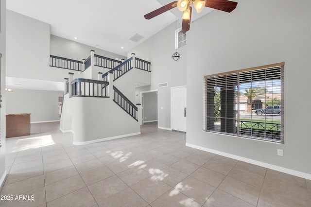 unfurnished living room featuring tile patterned floors, visible vents, and baseboards