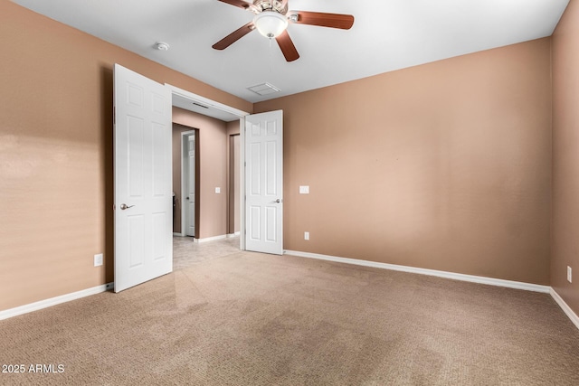 carpeted spare room with ceiling fan