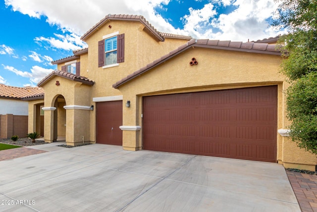 mediterranean / spanish house with a garage