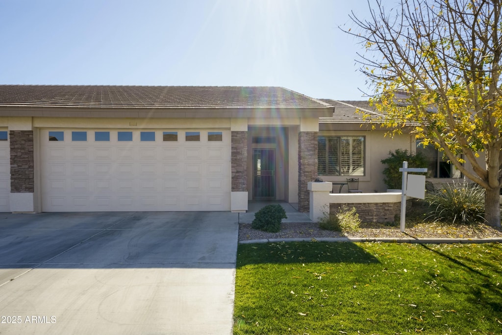 view of front of property featuring a garage and a front yard