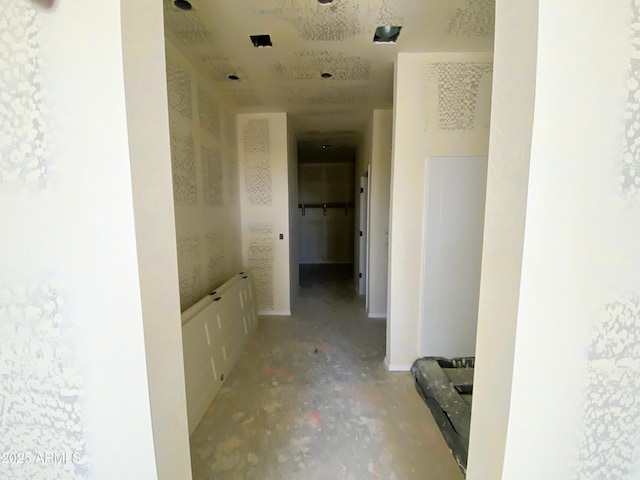 hall featuring concrete flooring