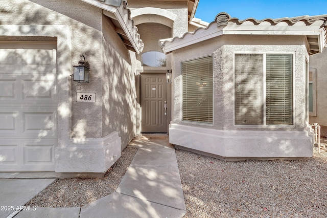 doorway to property featuring a garage