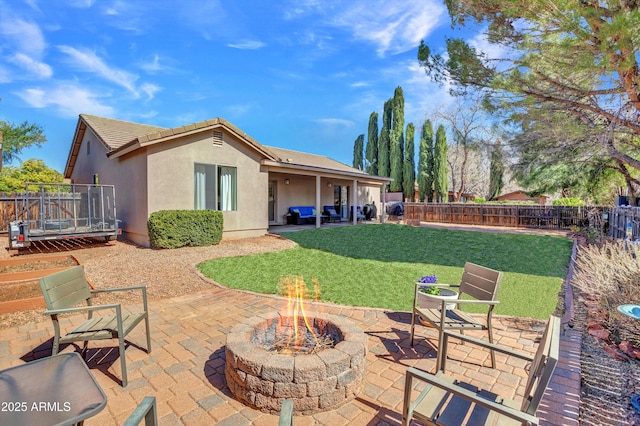 view of patio with an outdoor fire pit and a fenced backyard