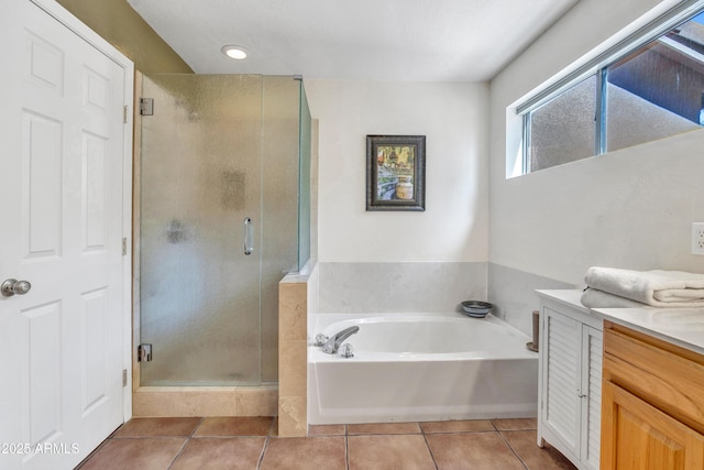 full bathroom featuring a bath, a stall shower, vanity, and tile patterned flooring