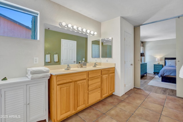 ensuite bathroom featuring tile patterned floors, double vanity, ensuite bath, and a sink