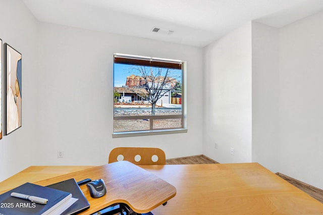 home office with wood finished floors and visible vents