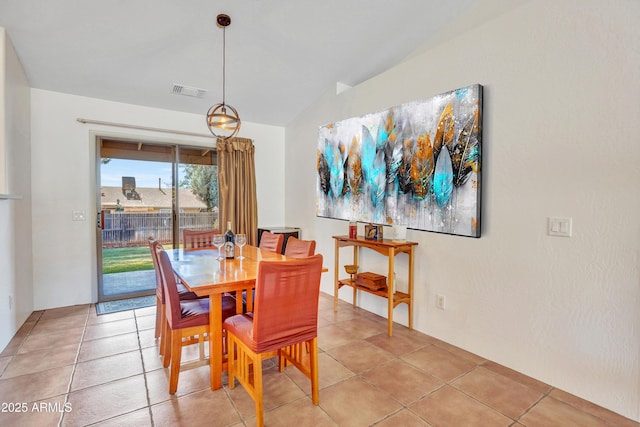 dining area with light tile patterned floors, visible vents, and lofted ceiling