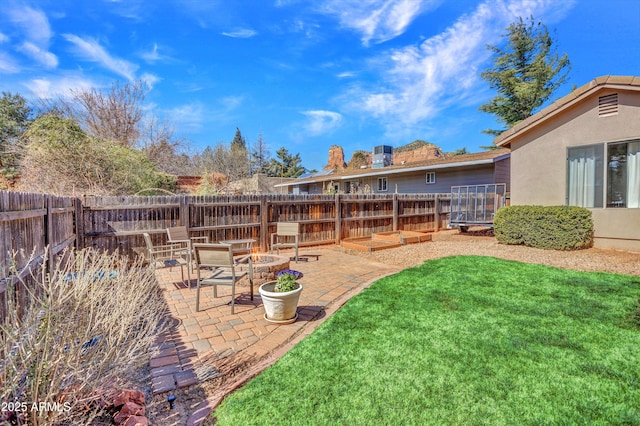 view of yard with an outdoor fire pit, a fenced backyard, and a patio area