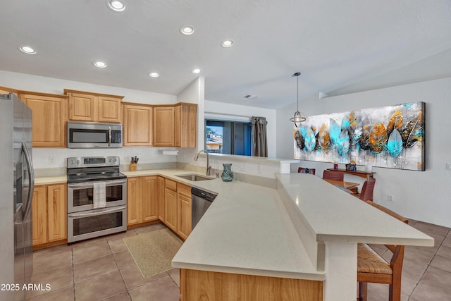 kitchen with light tile patterned floors, light brown cabinets, a peninsula, a sink, and stainless steel appliances