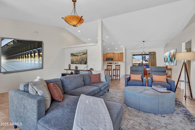 living area with vaulted ceiling, light tile patterned flooring, and recessed lighting