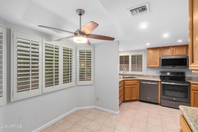 kitchen featuring ceiling fan, sink, light tile patterned floors, and stainless steel appliances