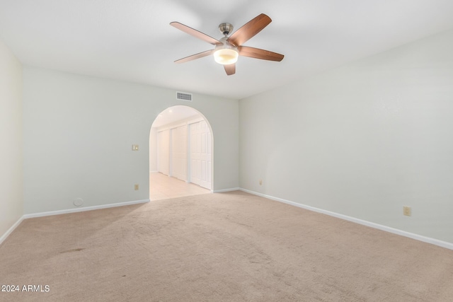 carpeted spare room with ceiling fan