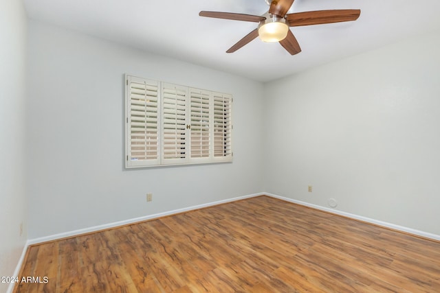 spare room featuring wood-type flooring and ceiling fan