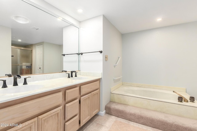 bathroom featuring tile patterned flooring, vanity, and shower with separate bathtub