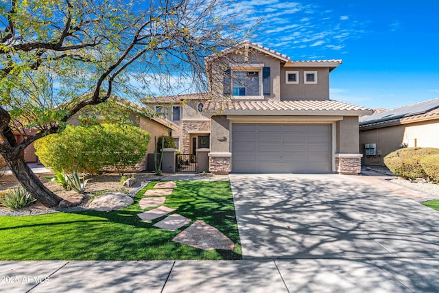 mediterranean / spanish home featuring a front yard and a garage