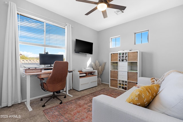 home office with ceiling fan, a wealth of natural light, and carpet