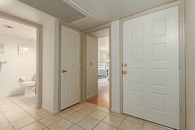 hallway featuring light tile patterned flooring