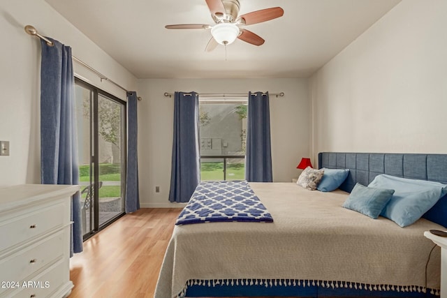 bedroom featuring access to outside, multiple windows, ceiling fan, and light wood-type flooring