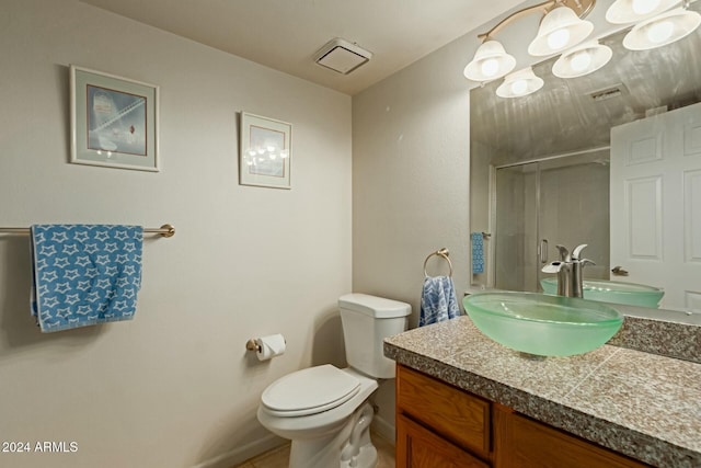 bathroom featuring vanity, toilet, and a shower with door