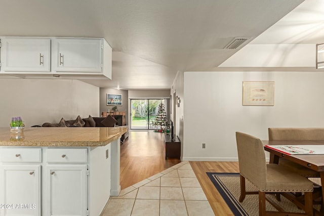 kitchen featuring white cabinetry and light hardwood / wood-style flooring