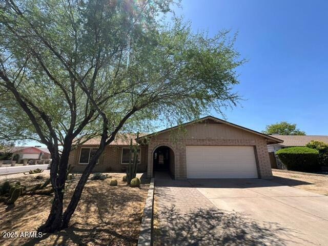 9402 N 48th Dr, Glendale, AZ 85302 - ranch-style house with a garage, brick siding, and driveway