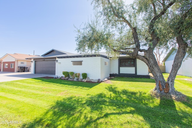 view of front of property with an attached garage, driveway, and a front lawn