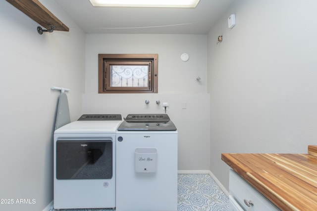 washroom with baseboards, laundry area, and washer and dryer