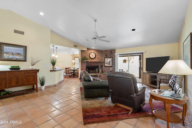 tiled living room with brick wall, lofted ceiling, ceiling fan, and a fireplace