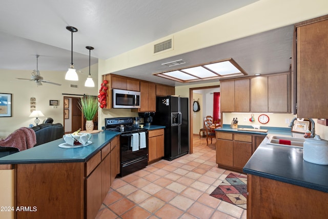 kitchen featuring a skylight, ceiling fan, light tile floors, decorative light fixtures, and black appliances