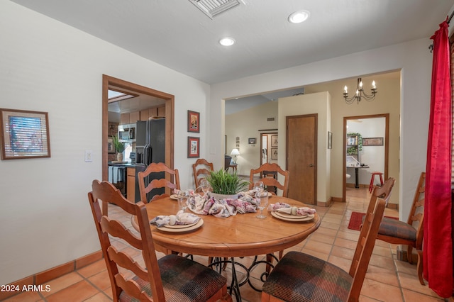 dining room with tile flooring and a chandelier