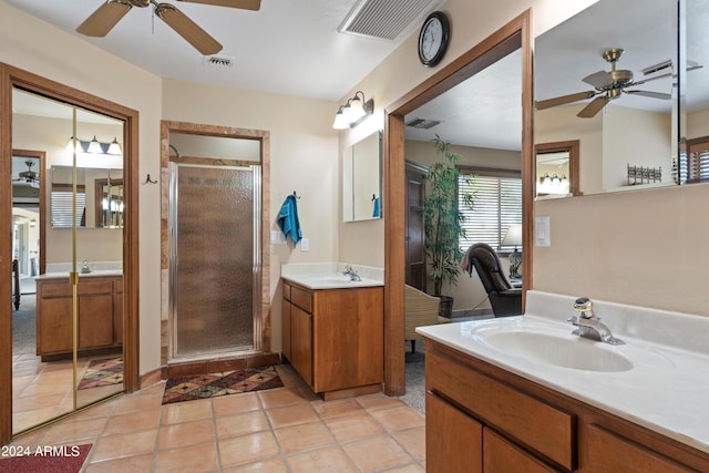 bathroom with tile floors, ceiling fan, dual vanity, and walk in shower