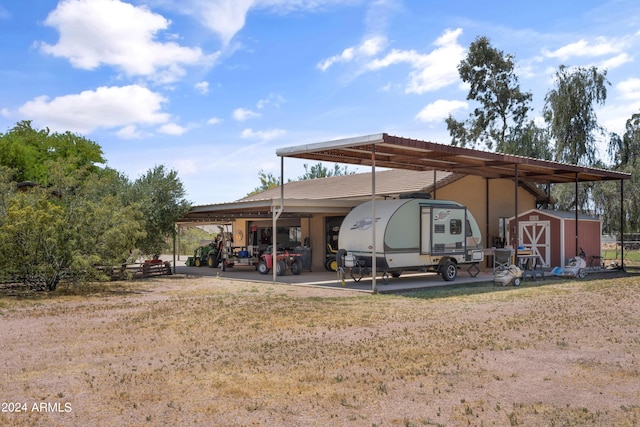 back of property featuring a storage unit