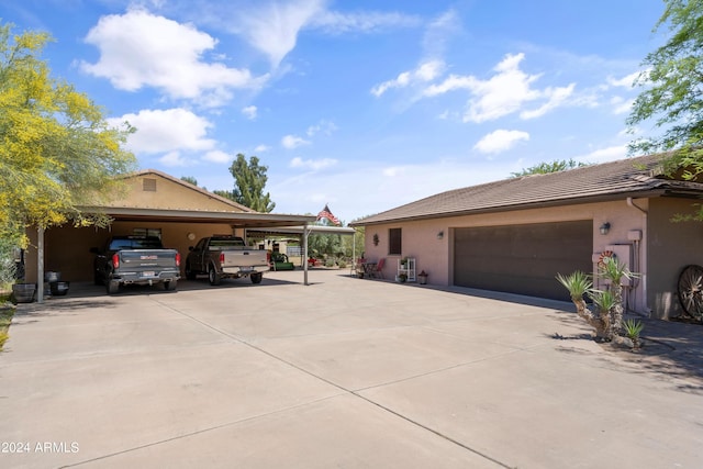 view of side of property featuring a garage and a carport