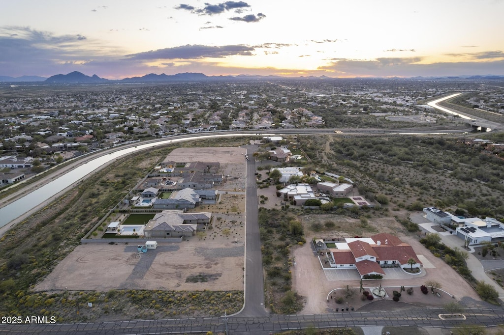 aerial view at dusk featuring a mountain view