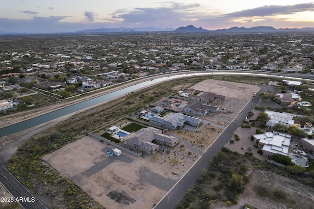 aerial view at dusk featuring a mountain view