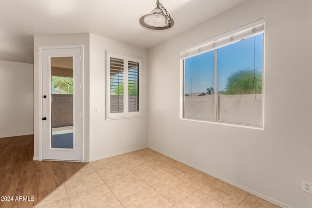 unfurnished room with light wood-type flooring