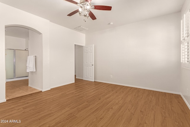 empty room with hardwood / wood-style floors and ceiling fan