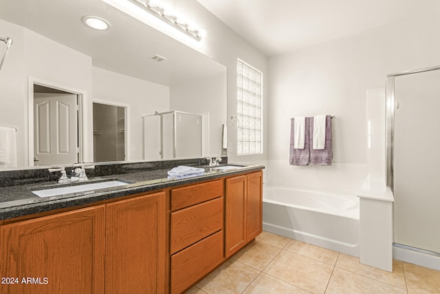 bathroom featuring independent shower and bath, tile patterned flooring, and vanity