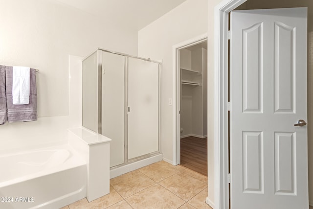 bathroom with independent shower and bath and tile patterned flooring