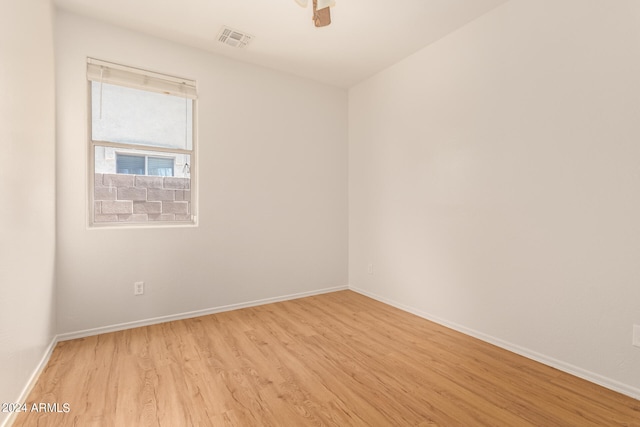 unfurnished room with light wood-type flooring