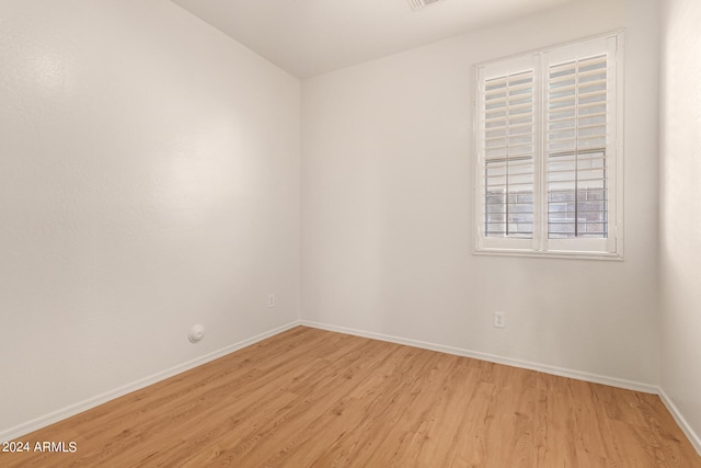 unfurnished room with light wood-type flooring