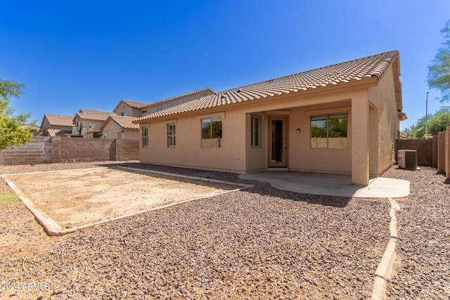 back of house with cooling unit and a patio area