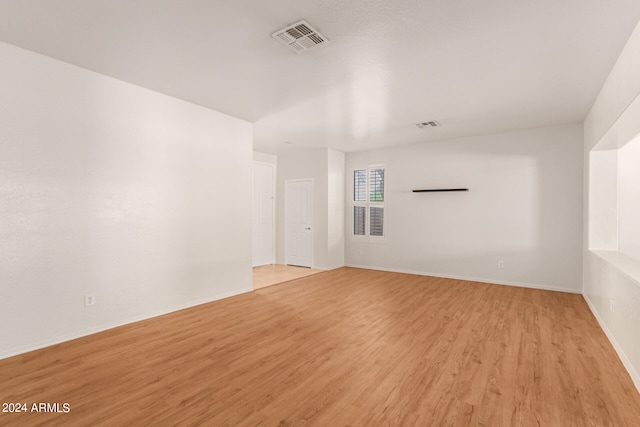 unfurnished room with light wood-type flooring